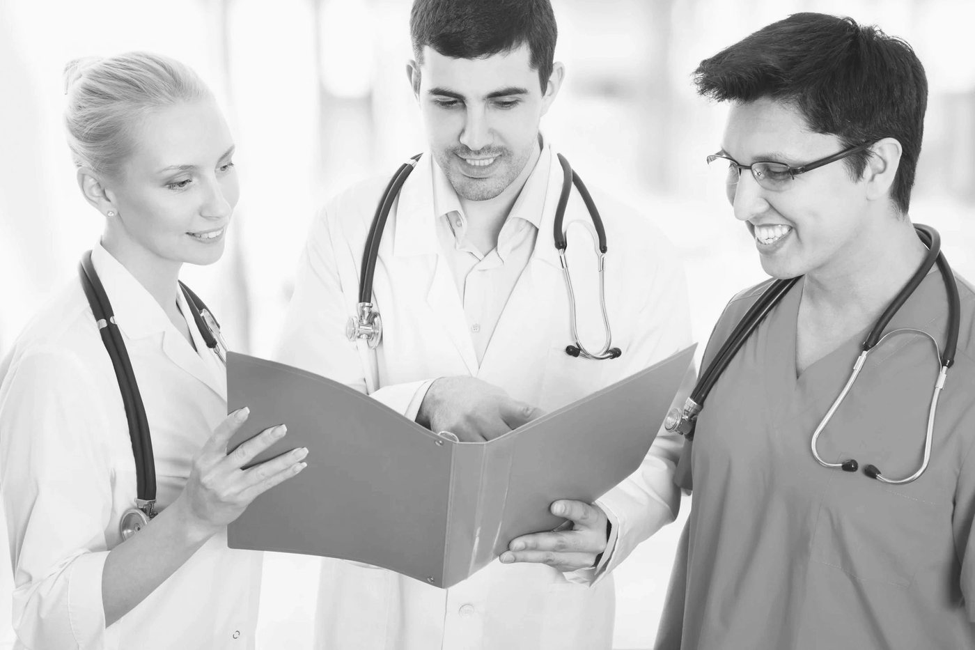 Three clinicians reviewing a folder together