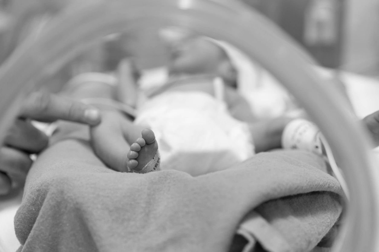 Preterm infant lying in an incubator